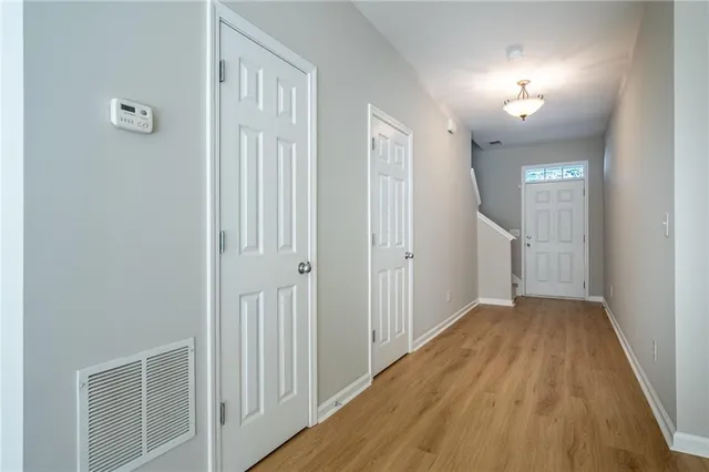 a view of a hallway with wooden floor
