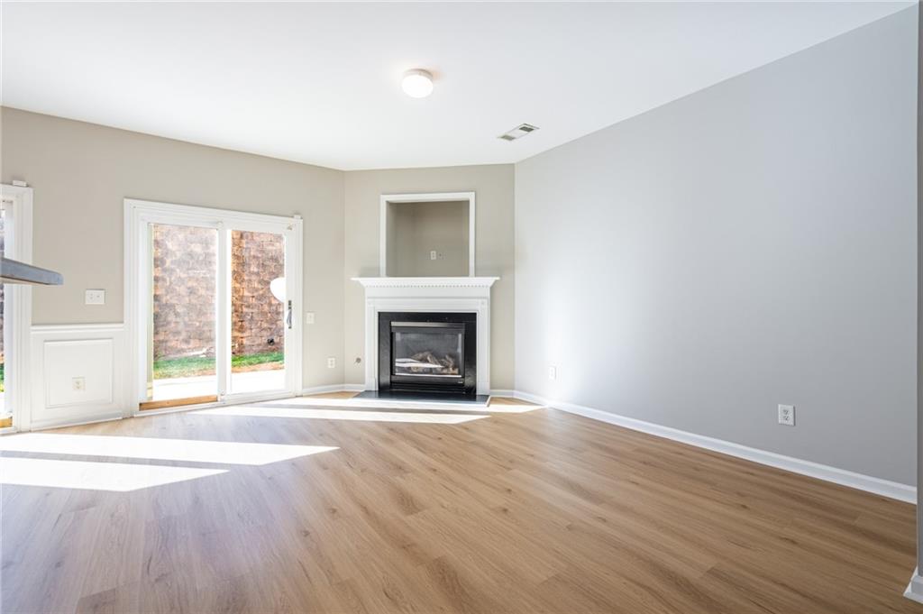 2245 Leicester Way Southeast Atlanta, GA 30316 - Photo 7 of 29 a view of an empty room with wooden floor and a window