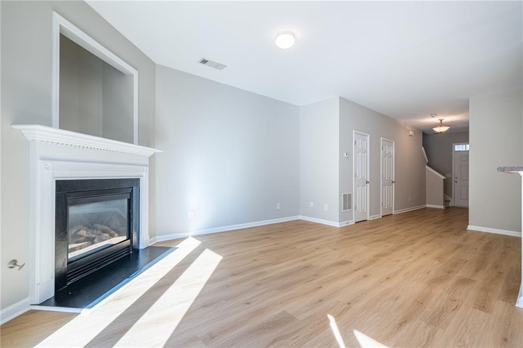 2245 Leicester Way Southeast Atlanta, GA 30316 - Photo 8 of 29 a view of empty room with wooden floor and fireplace