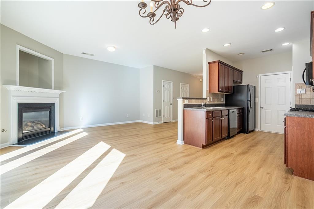 2245 Leicester Way Southeast Atlanta, GA 30316 - Photo 10 of 29 a kitchen with stainless steel appliances granite countertop a stove top oven a sink and a refrigerator