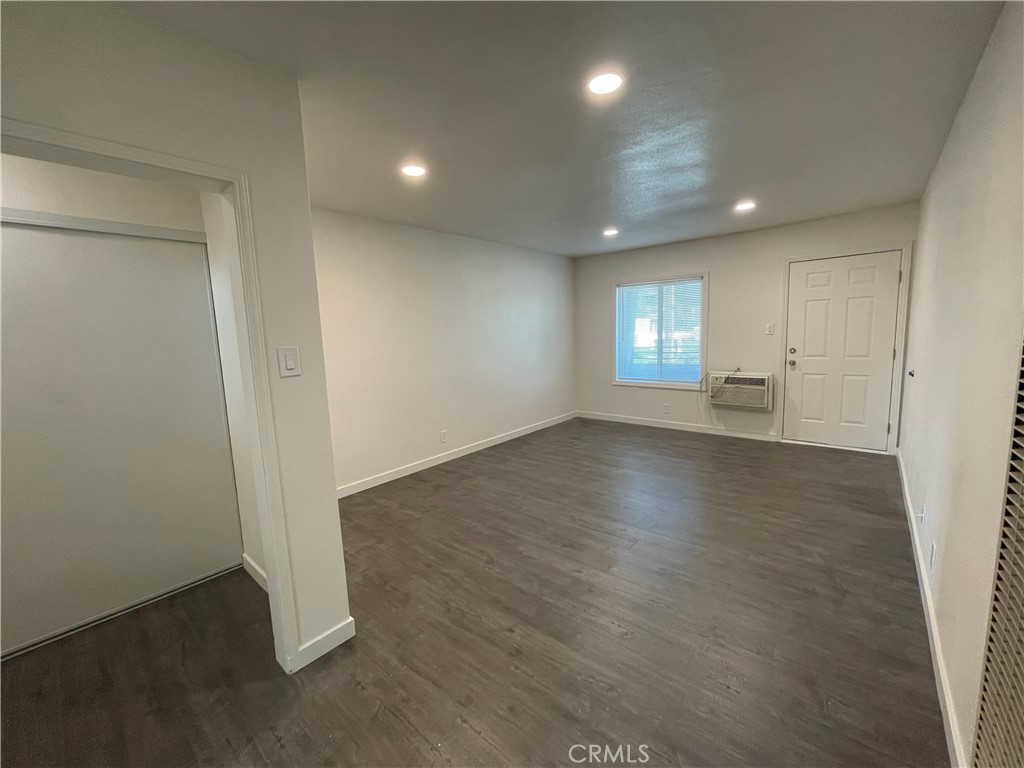 1349 North Altadena Drive, Unit B Pasadena, CA 91107 - Photo 2 of 8 an empty room with wooden floor and windows
