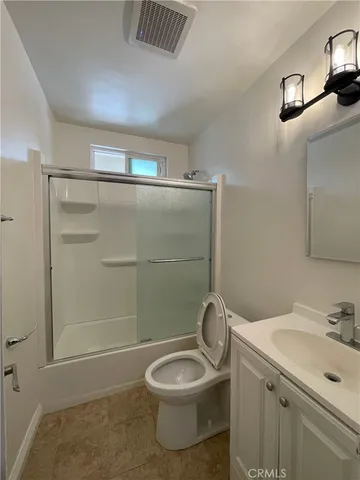 a bathroom with a toilet a sink and shower