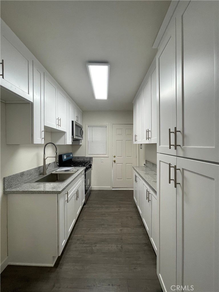 1349 North Altadena Drive, Unit B Pasadena, CA 91107 - Photo 6 of 8 a kitchen with stainless steel appliances granite countertop a sink a stove and a refrigerator