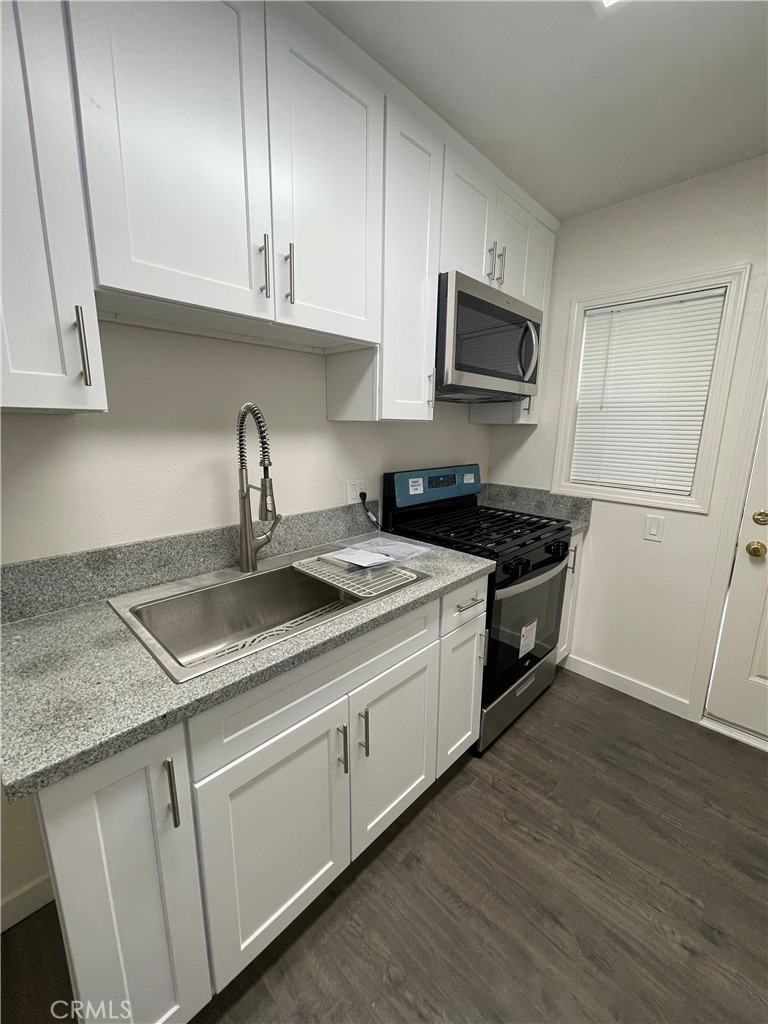 1349 North Altadena Drive, Unit B Pasadena, CA 91107 - Photo 7 of 8 a kitchen with granite countertop a sink a stove and cabinets