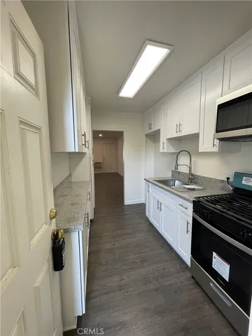 a kitchen with stainless steel appliances granite countertop a stove and a sink