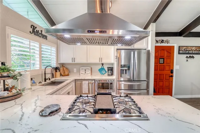 a kitchen with sink and a stove