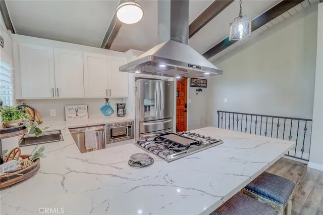 a kitchen with a stove a sink and a dining table