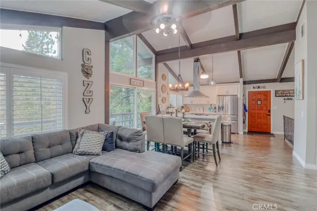a bedroom with a bed and a potted plant on the dresser