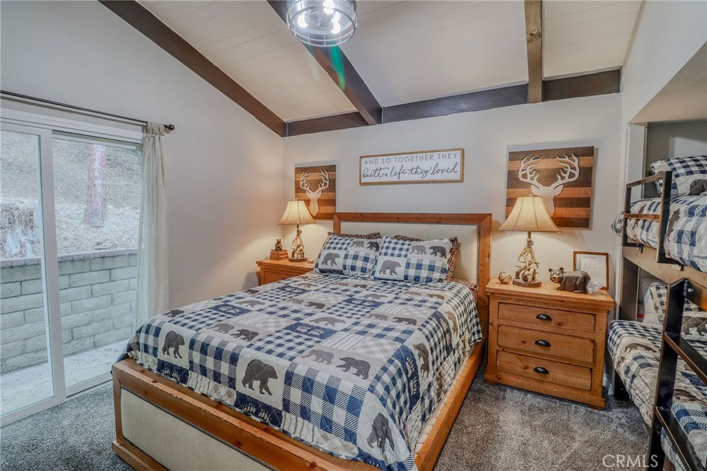 26669 Highway 189 Twin Peaks, CA 92391 - Photo 21 of 68 a bedroom with a bed and wooden floor