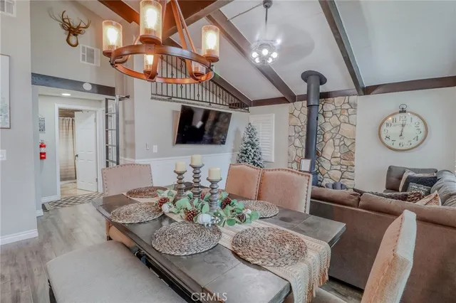 a room with furniture pool table flat screen tv and a chandelier