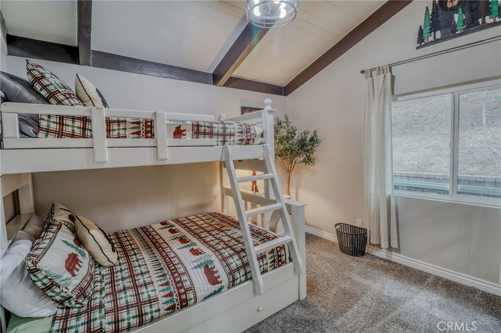 26669 Highway 189 Twin Peaks, CA 92391 - Photo 24 of 68 a bedroom with a bed and a potted plant on the dresser