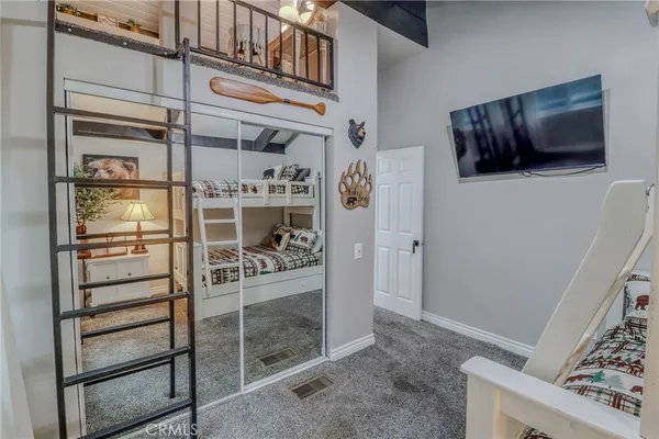 a living room with furniture a flat screen tv and a table