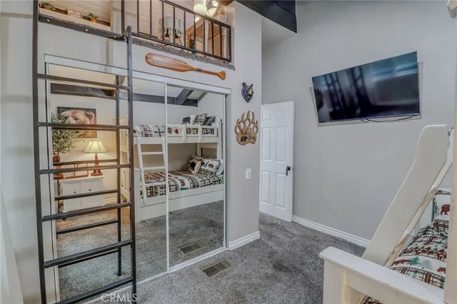 a living room with furniture a flat screen tv and a table