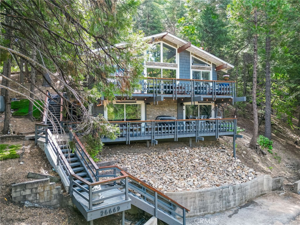 26669 Highway 189 Twin Peaks, CA 92391 - Photo 3 of 68 a front view of a house with garden