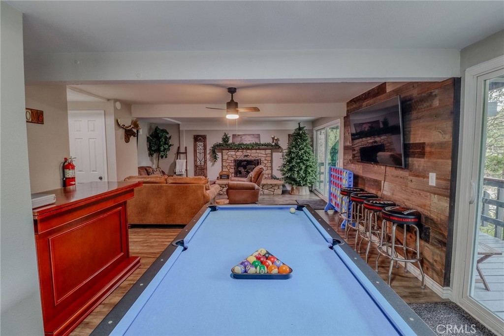26669 Highway 189 Twin Peaks, CA 92391 - Photo 35 of 68 a living room with furniture a flat screen tv and a table