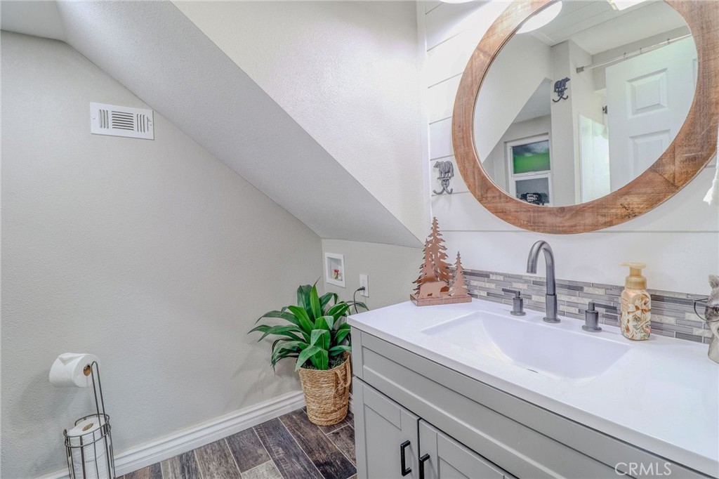 26669 Highway 189 Twin Peaks, CA 92391 - Photo 36 of 68 a bathroom with a sink and a mirror
