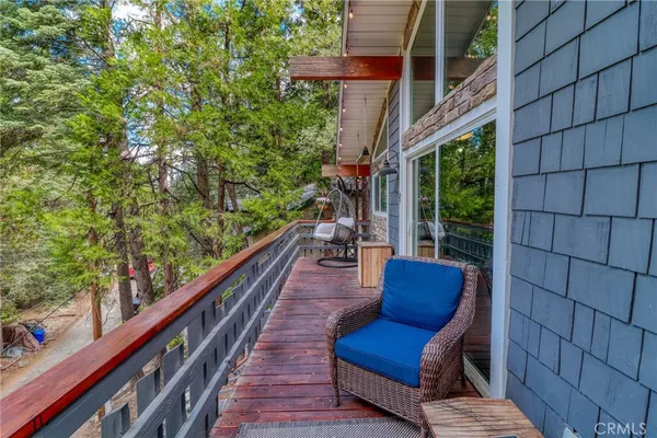 a view of a two chairs in the deck next to a yard