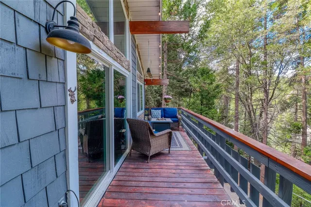 a backyard of a house with large trees and wooden fence