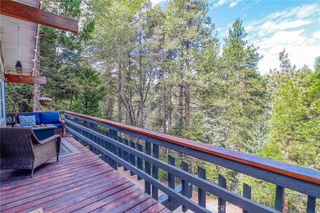 a view of a deck with furniture and a backyard