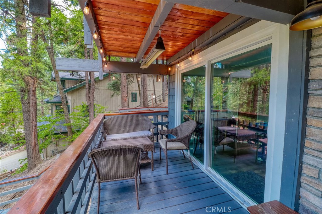 26669 Highway 189 Twin Peaks, CA 92391 - Photo 54 of 68 a balcony with furniture and wooden floor