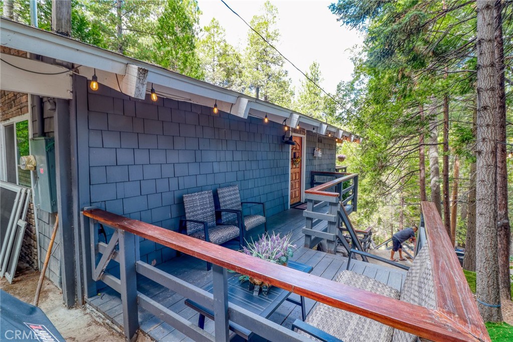 26669 Highway 189 Twin Peaks, CA 92391 - Photo 62 of 68 a backyard of a house with large trees and wooden fence