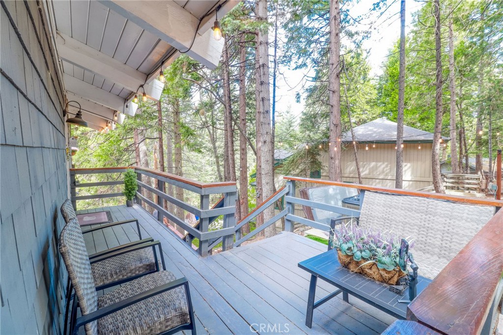 26669 Highway 189 Twin Peaks, CA 92391 - Photo 63 of 68 a view of a deck with furniture and a backyard