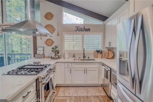 a kitchen with stainless steel appliances granite countertop a stove and a refrigerator