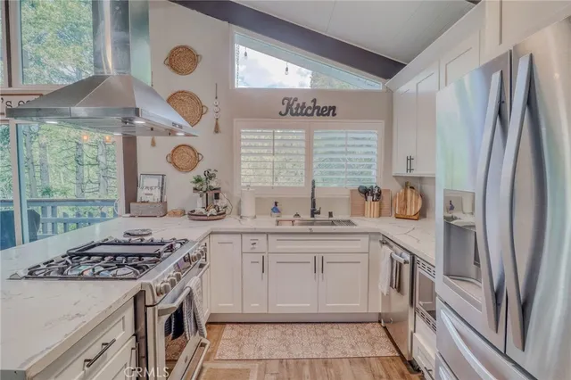 a kitchen with stainless steel appliances granite countertop a stove and a refrigerator