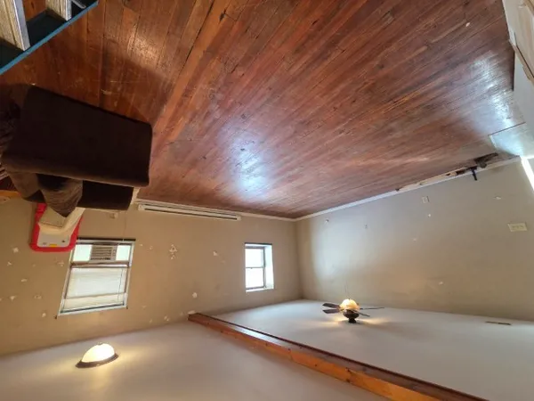 a room with gym equipment and a window