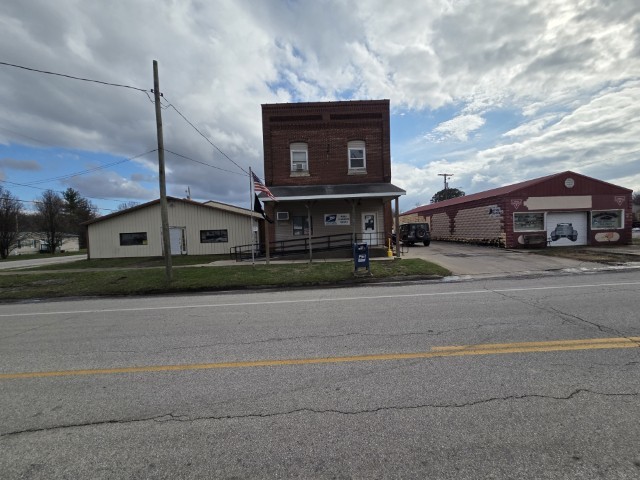 303 3rd Street Kell, IL 62853 - Photo 23 of 23 a city view with tall buildings and a street sign on a wall