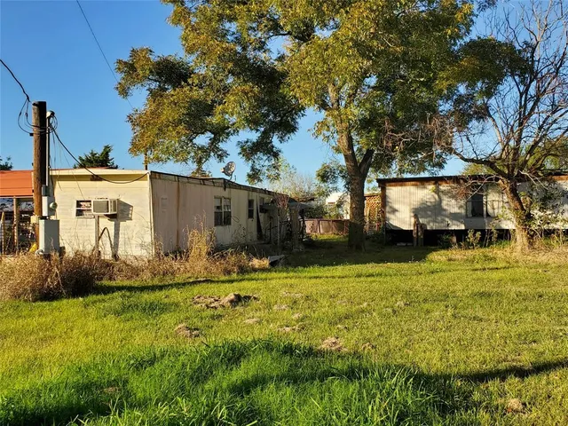 a backyard of apartments with large trees