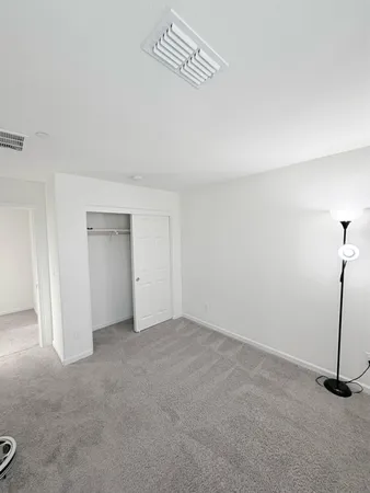a view of an empty room with glass door