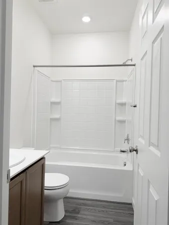 a bathroom with a toilet and a bathtub