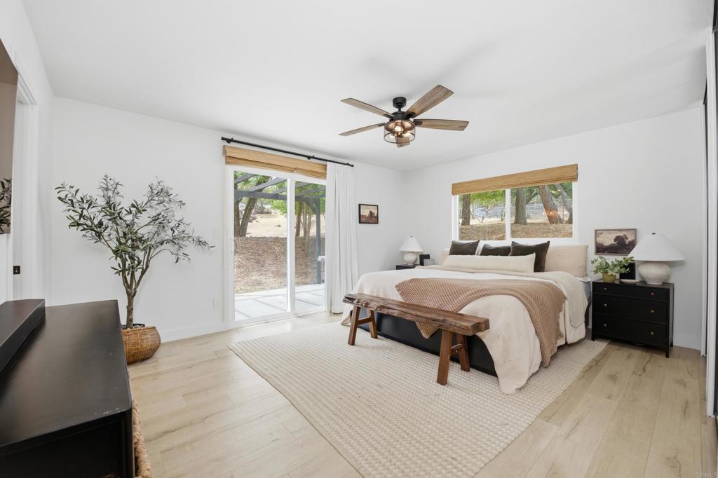 1878 Rancho Jorie Alpine, CA 91901 - Photo 12 of 70 a spacious bedroom with a large bed and a potted plant