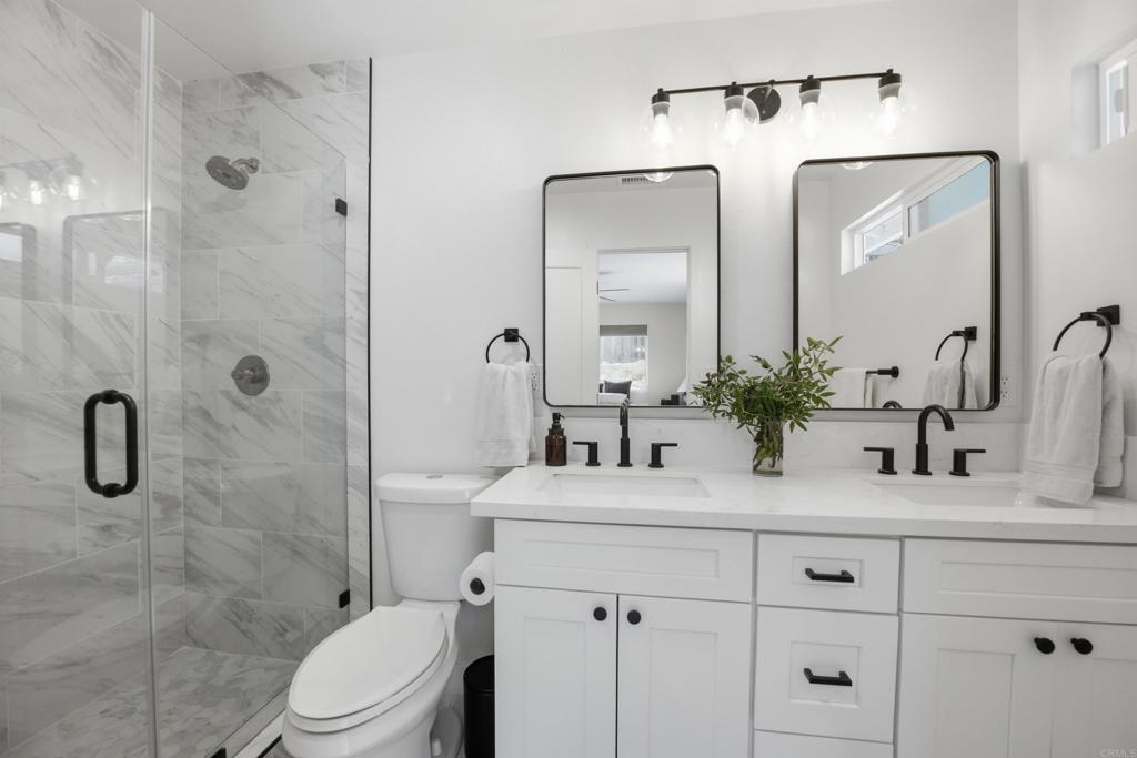 1878 Rancho Jorie Alpine, CA 91901 - Photo 14 of 70 a bathroom with a double vanity sink mirror and toilet
