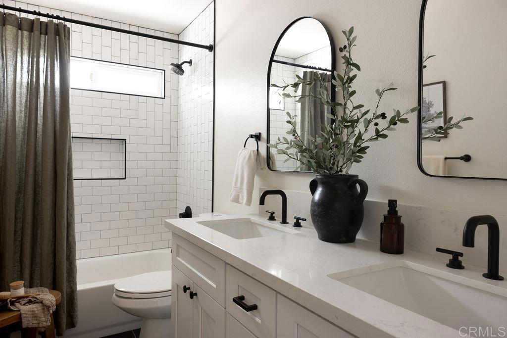 1878 Rancho Jorie Alpine, CA 91901 - Photo 66 of 70 a bathroom with a double vanity sink toilet and shower