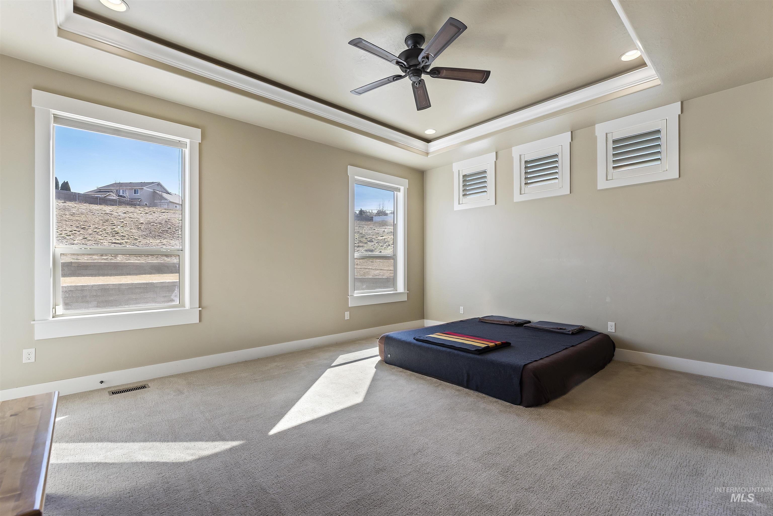 24710 Blessinger Road Star, ID 83669 - Photo 14 of 46 Unfurnished bedroom featuring a raised ceiling, carpet, ceiling fan, and recessed lighting