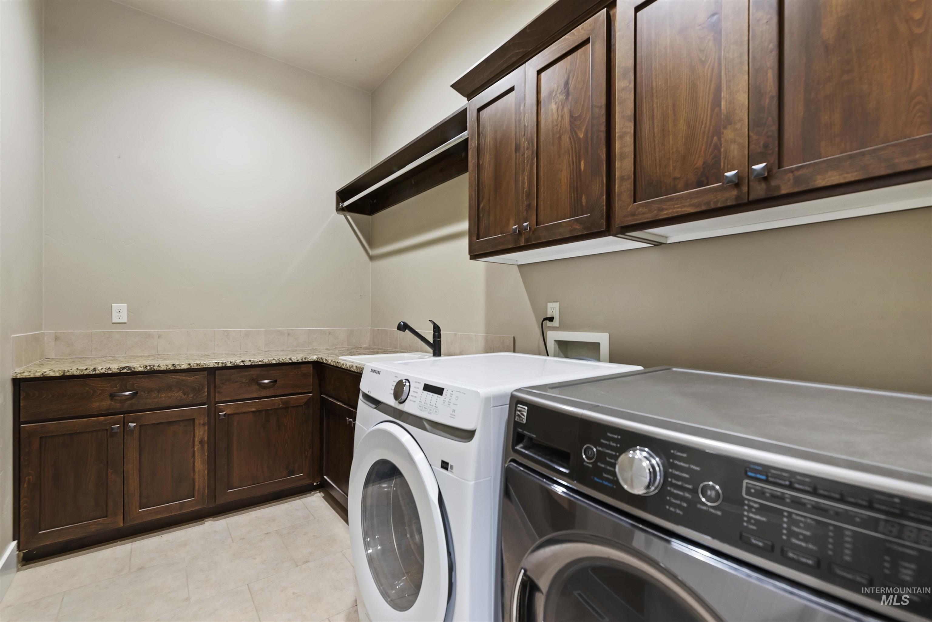 24710 Blessinger Road Star, ID 83669 - Photo 25 of 46 Laundry room with cabinet space, independent washer and dryer, and light tile patterned flooring