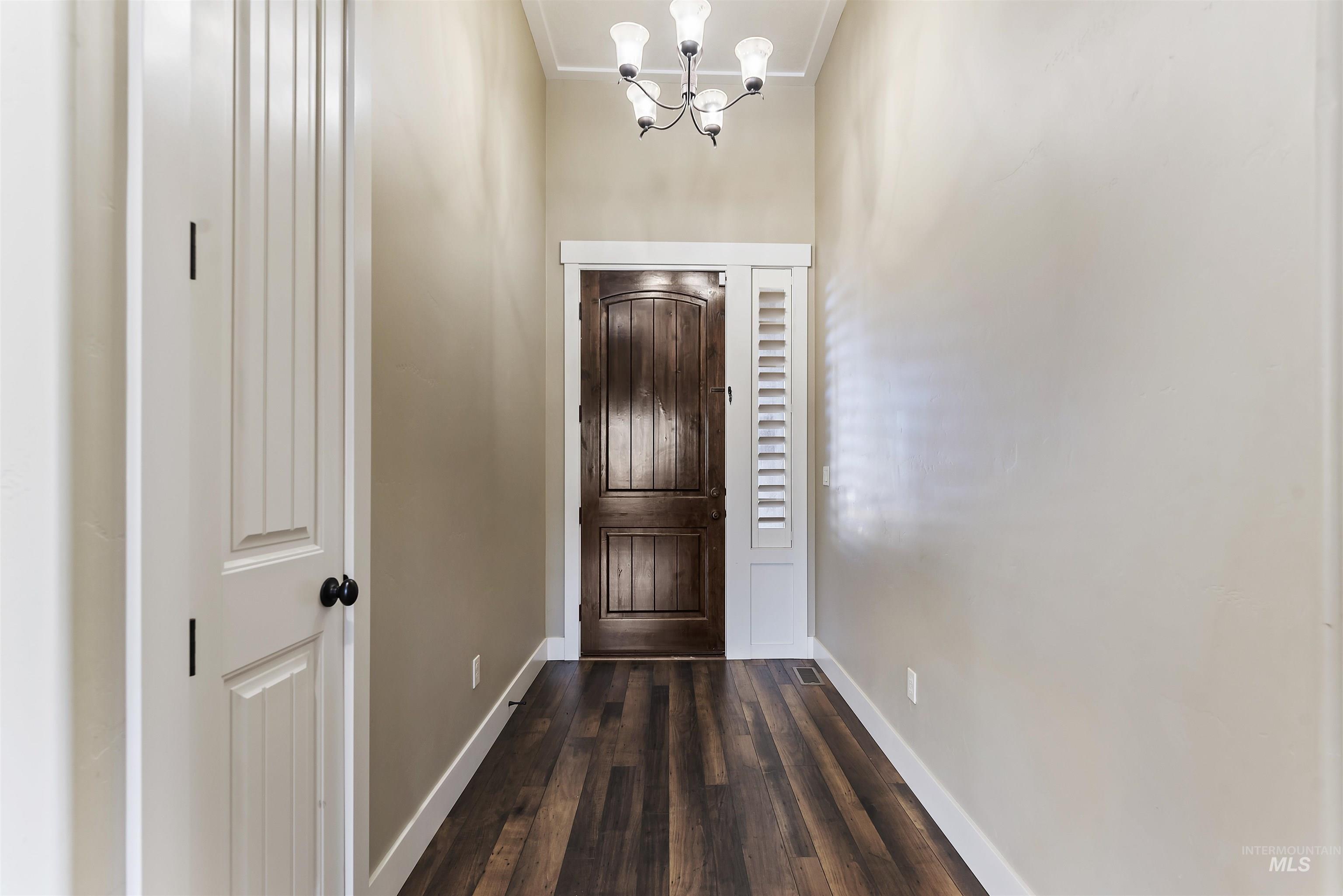 24710 Blessinger Road Star, ID 83669 - Photo 28 of 46 Foyer entrance with suspended lighting and dark wood-type flooring