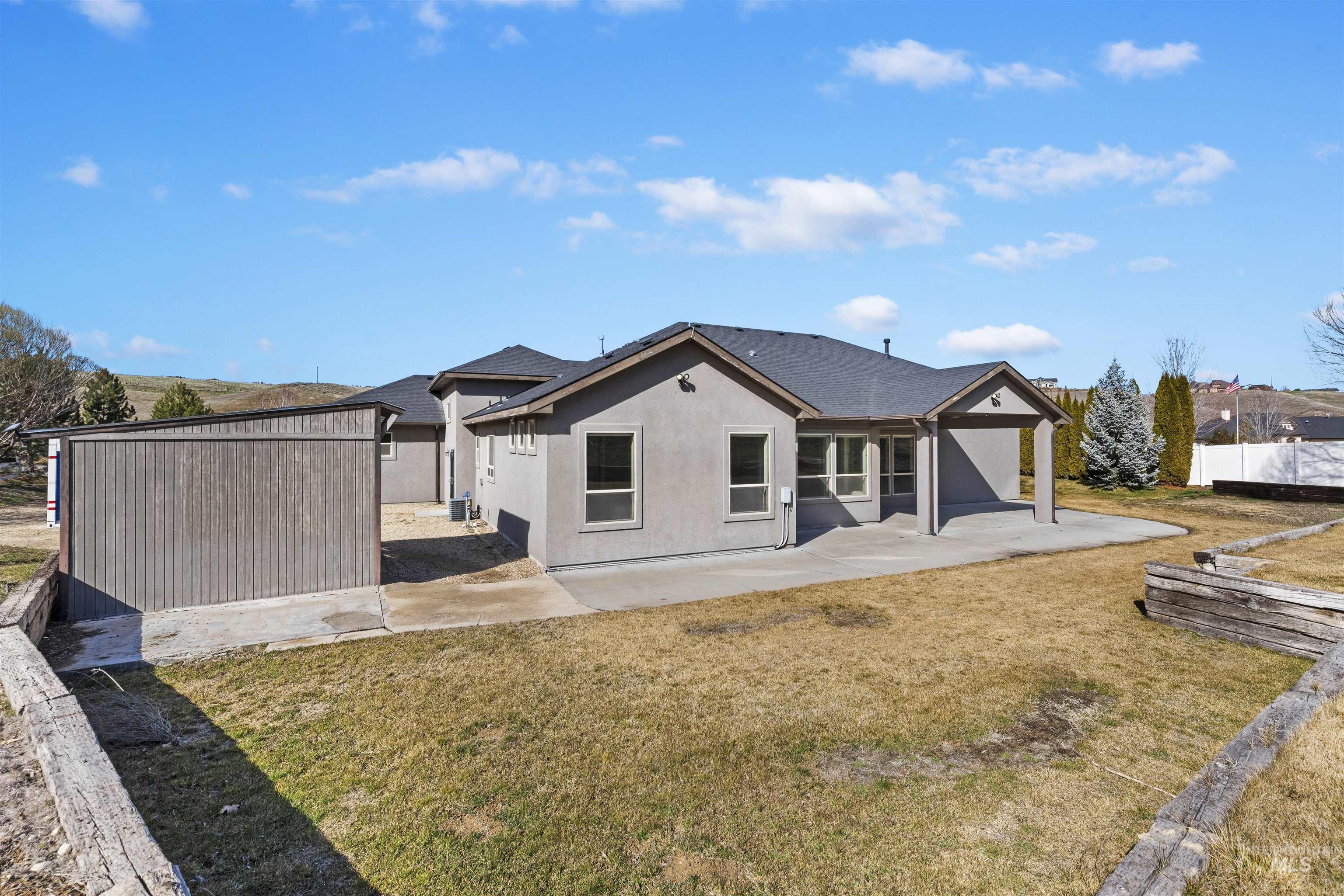 24710 Blessinger Road Star, ID 83669 - Photo 29 of 46 Back of house featuring stucco siding and a patio