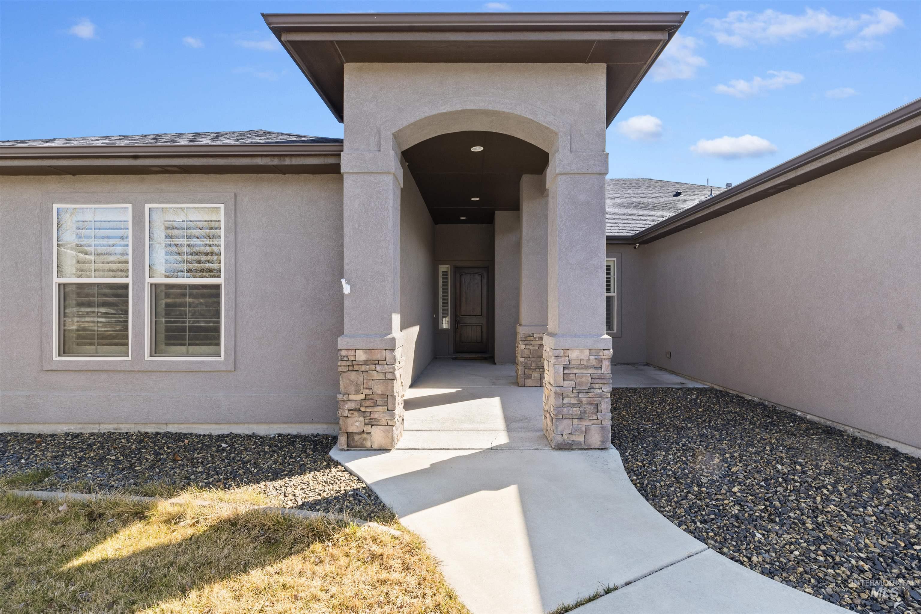 24710 Blessinger Road Star, ID 83669 - Photo 6 of 46 Doorway to property with stucco siding and stone siding