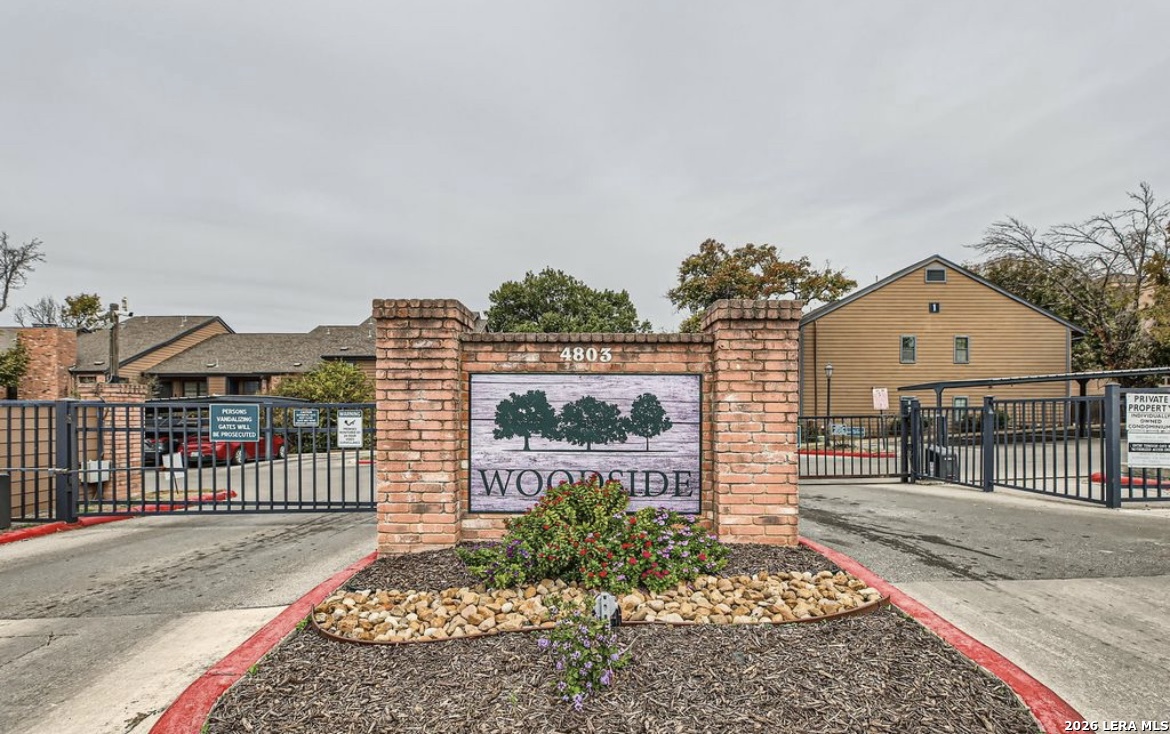 a view of a brick house with large windows