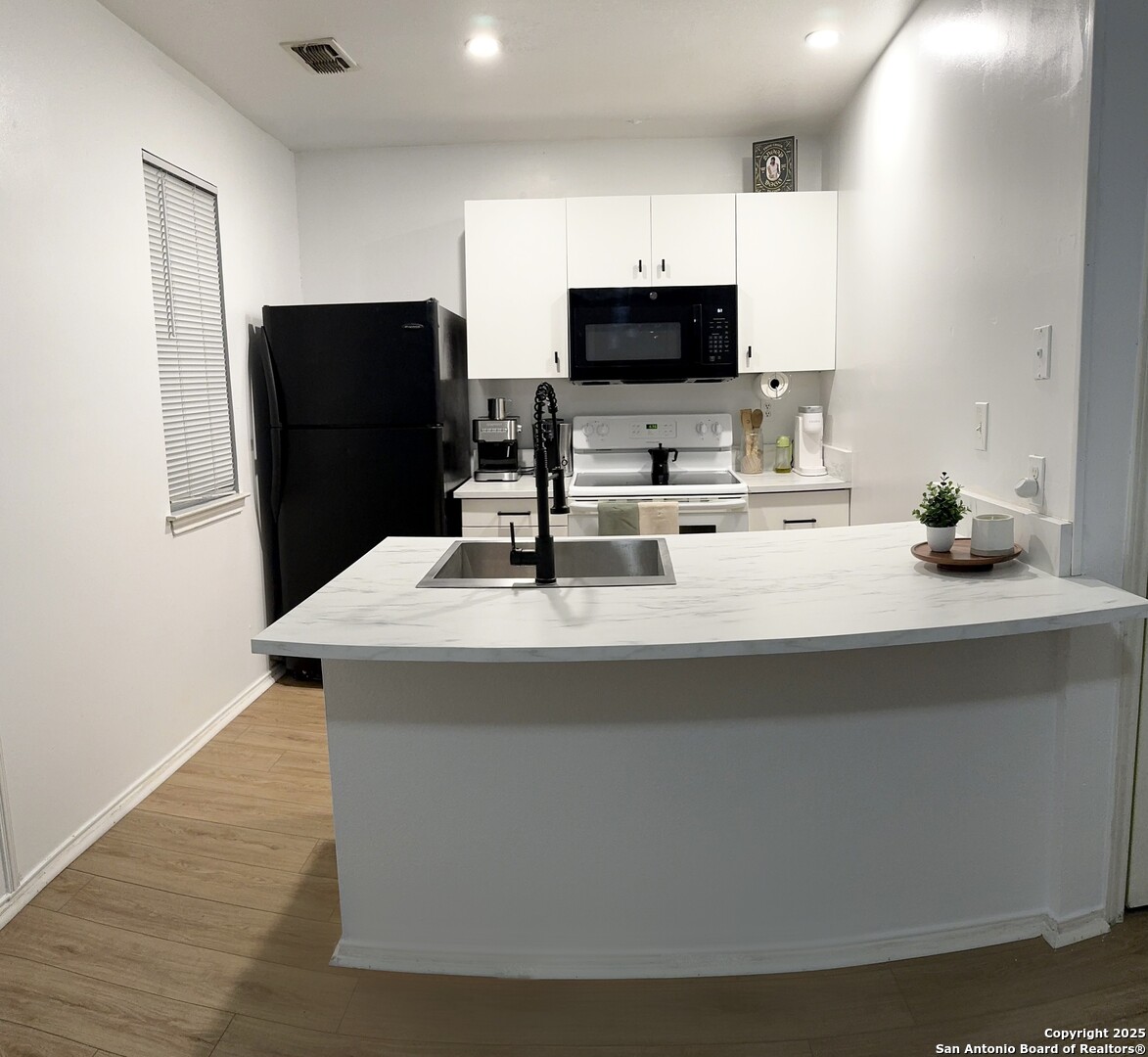 4803 Hamilton Wolfe Road, Unit 310 San Antonio, TX 78229 - Photo 2 of 5 a kitchen with a appliances and a sink