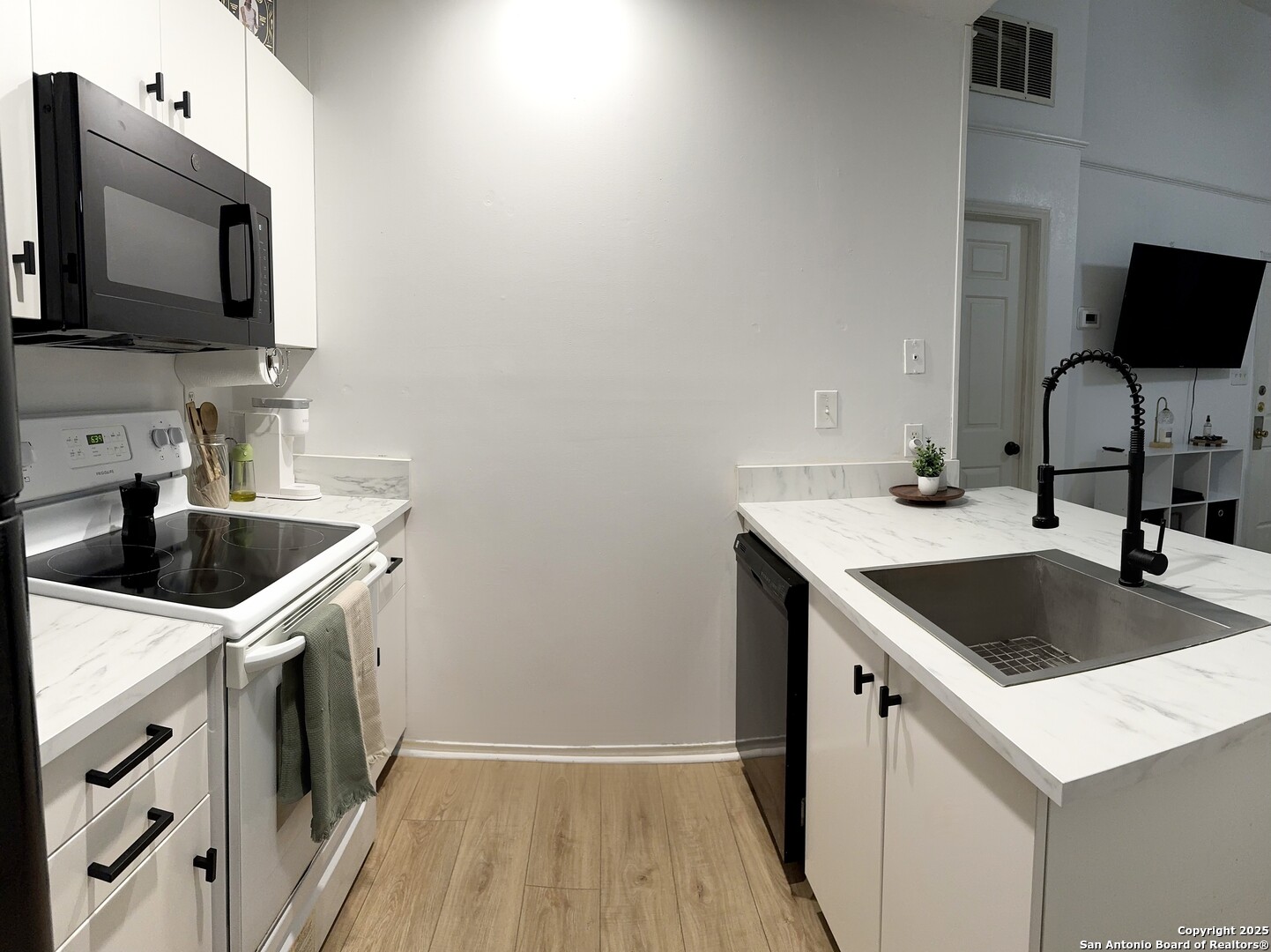 4803 Hamilton Wolfe Road, Unit 310 San Antonio, TX 78229 - Photo 3 of 5 a kitchen with a sink stove and microwave