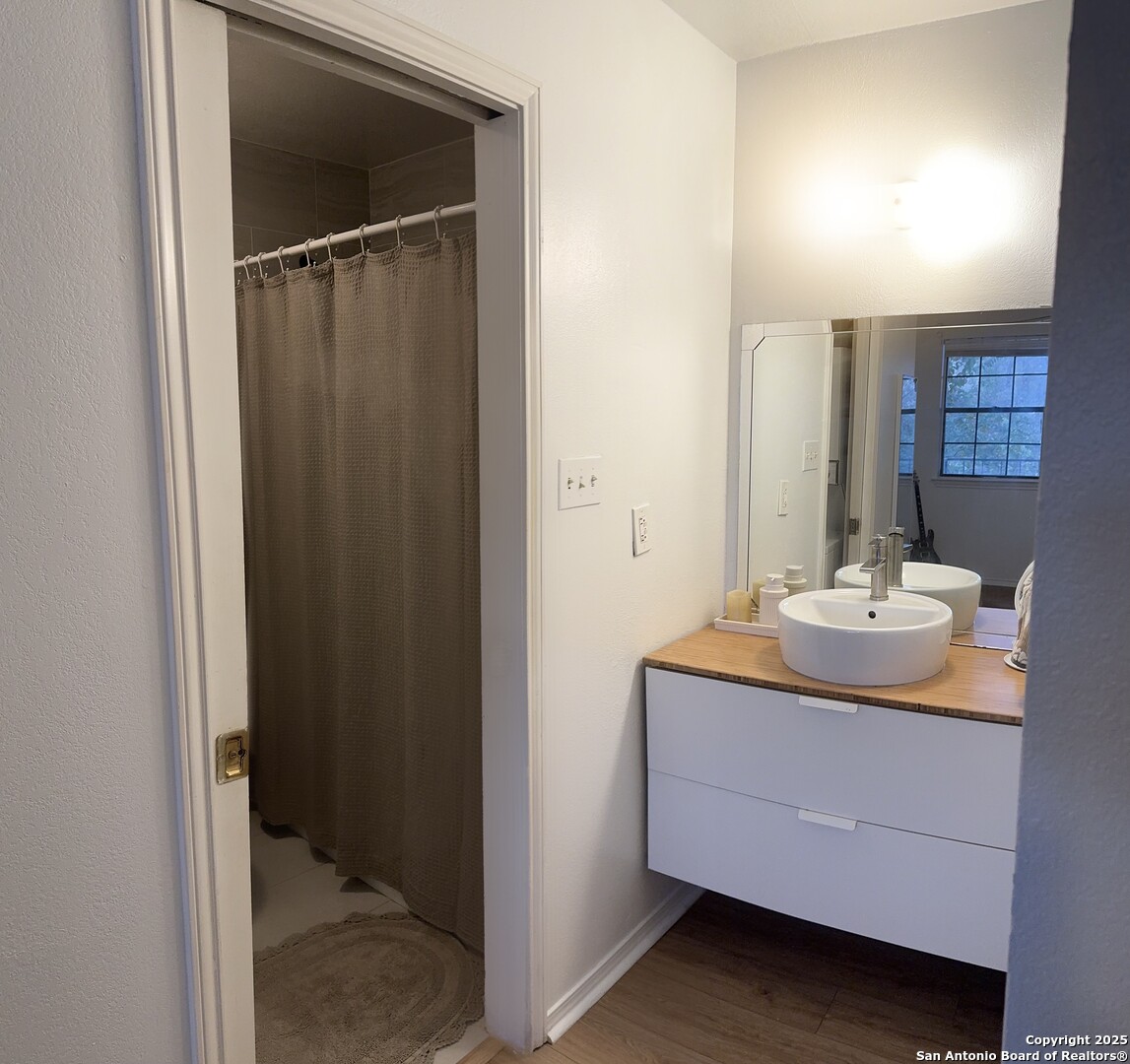4803 Hamilton Wolfe Road, Unit 310 San Antonio, TX 78229 - Photo 4 of 5 a bathroom with a sink and a mirror