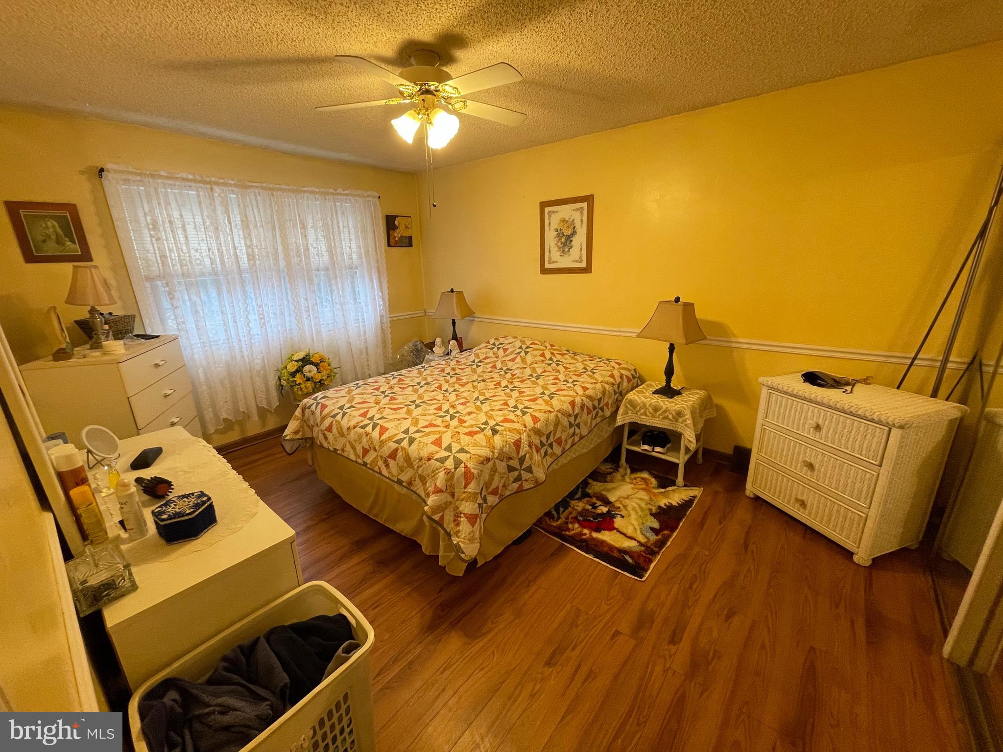 12014 Tyrone Road Philadelphia, PA 19154 - Photo 16 of 32 a bedroom with a bed and wooden floor