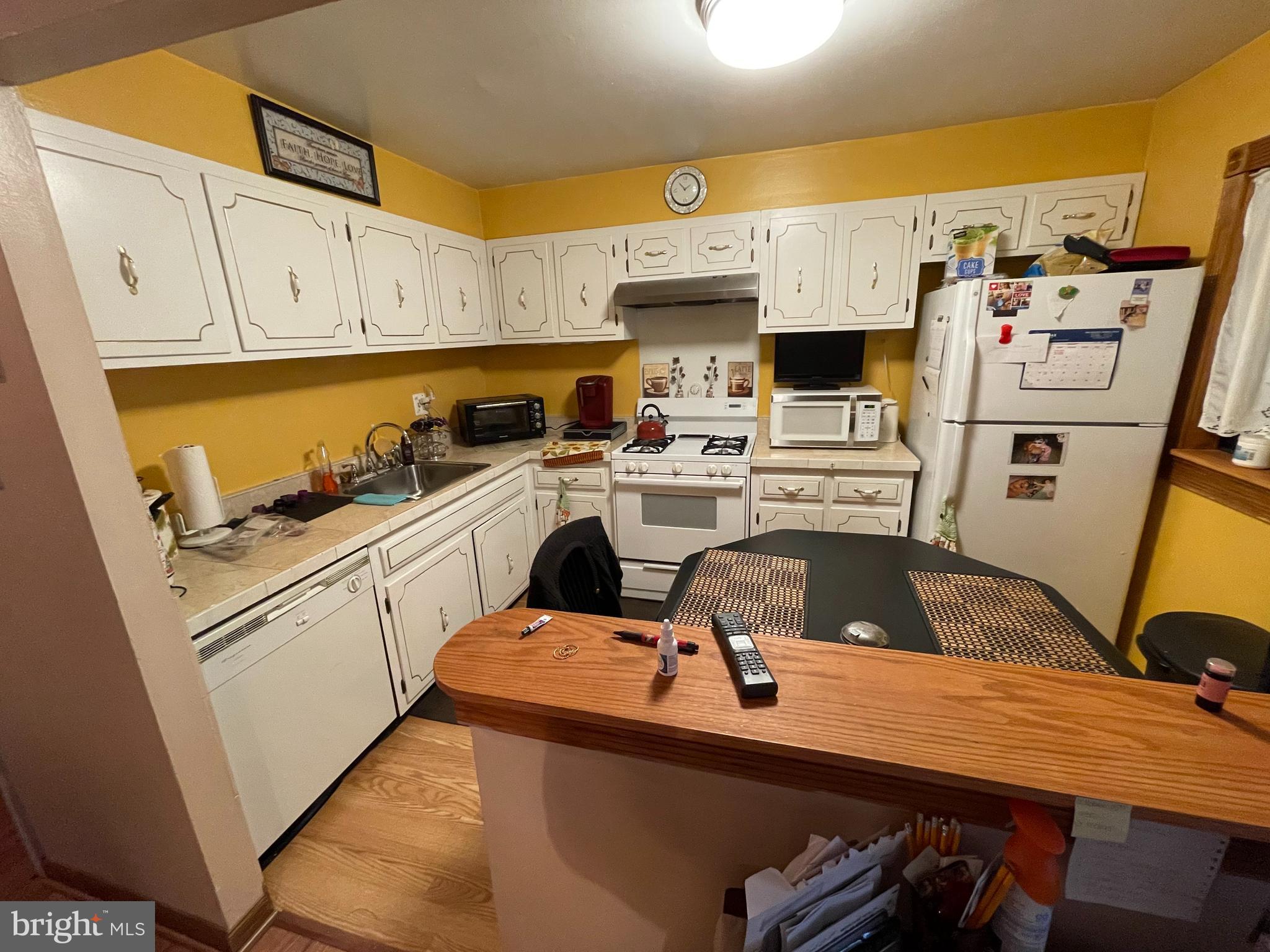 12014 Tyrone Road Philadelphia, PA 19154 - Photo 9 of 32 a kitchen with a sink a stove and cabinets