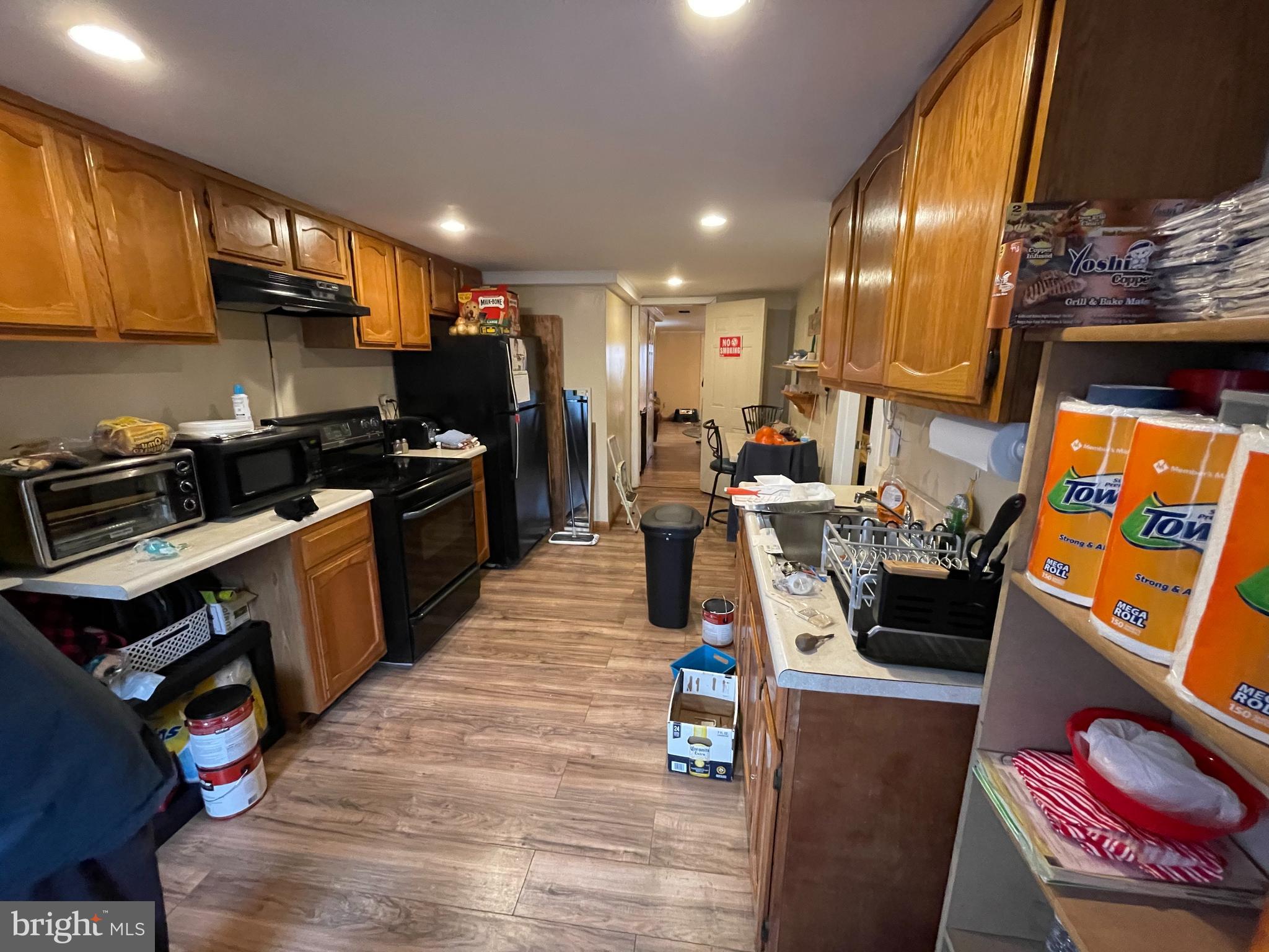 12014 Tyrone Road Philadelphia, PA 19154 - Photo 10 of 32 a kitchen with stainless steel appliances granite countertop a stove top oven a sink dishwasher and cabinets with wooden floor