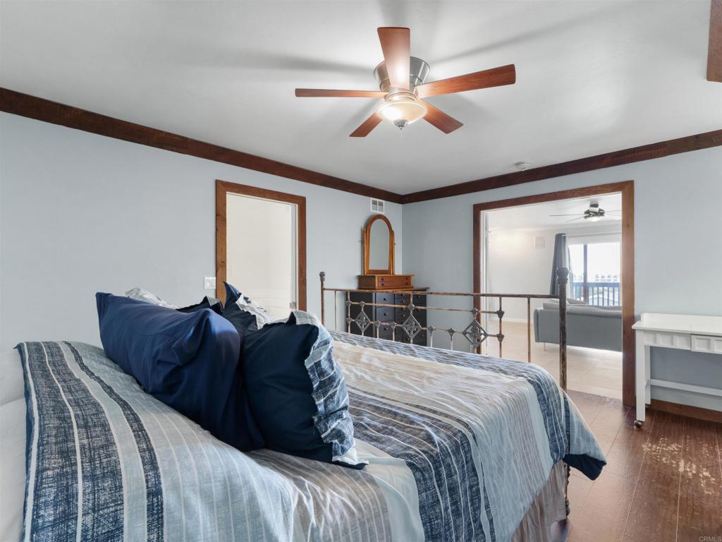 852 Dewitt Avenue Encinitas, CA 92024 - Photo 3 of 41 a bedroom with a large bed and a chandelier