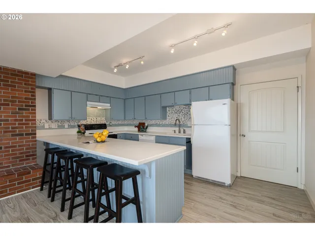 a kitchen with kitchen island a table and chairs
